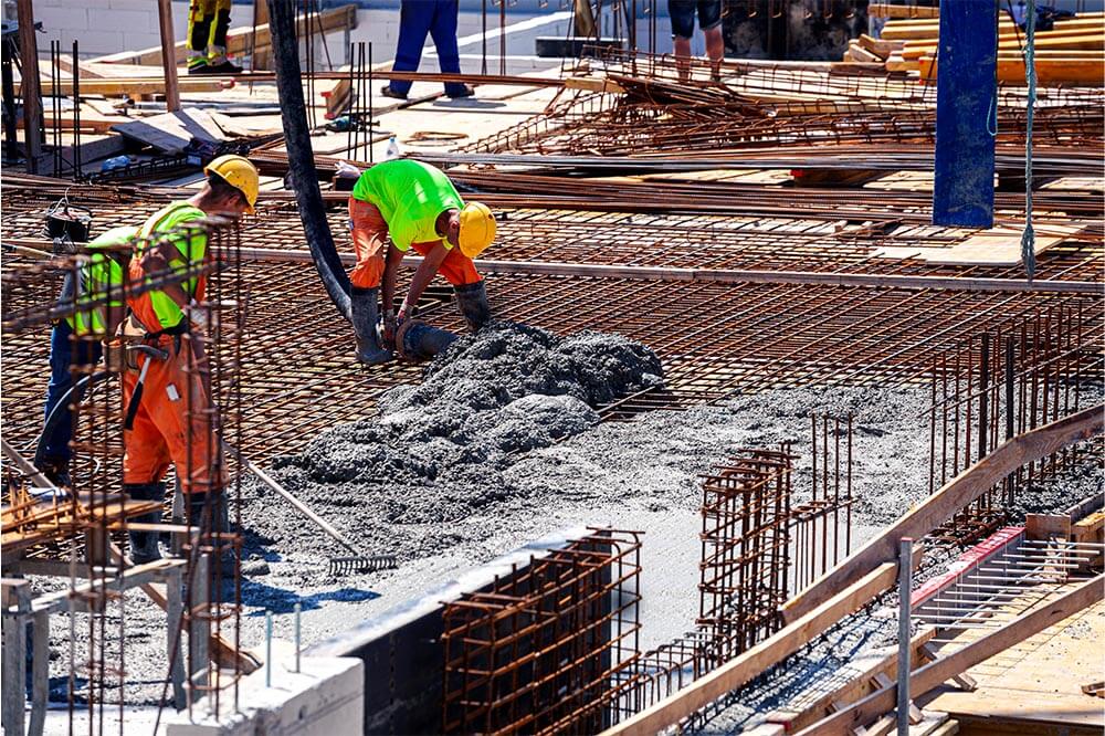 constructor worker pouring concrete on a job site