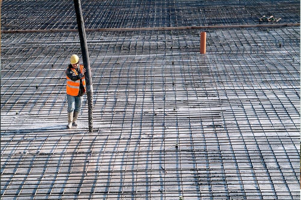 construction worker pouring concrete 